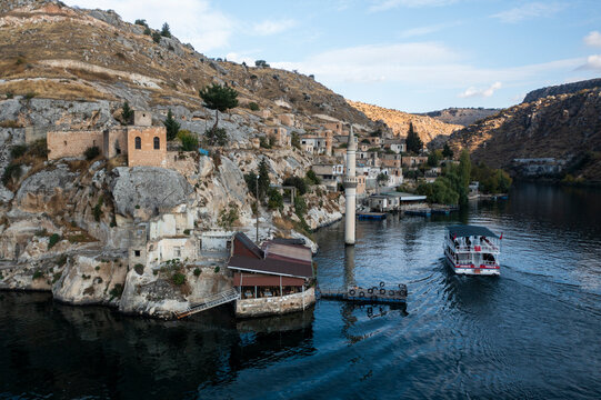 Aerial view of serene Halfeti with historic buildings along the river and rocky cliffs, Sanliurfa, Turkiye.