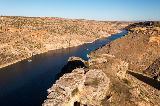 Aerial view of a breathtaking canyon with a serene river and rugged cliffs, Egil, Turkiye.