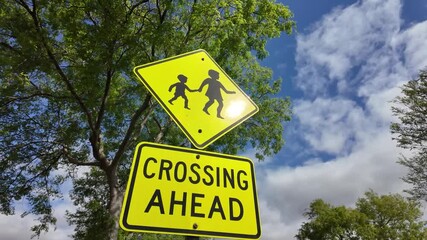 A retroreflective regulatory road sign for warning children crossing ahead in Australia. It alerts drivers to slow down and be vigilant for young pedestrians. 