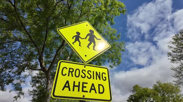 A retroreflective regulatory road sign for warning children crossing ahead in Australia. It alerts drivers to slow down and be vigilant for young pedestrians. 