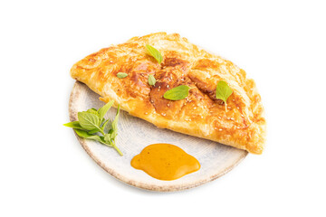 Fried homemade khachapuri cake with cheese and meat, fried in pan isolated on white. Side view
