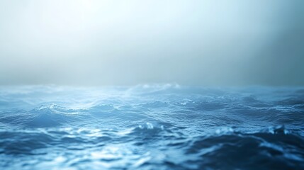 A serene view of calm ocean waves under a misty atmosphere.