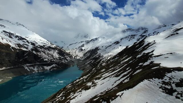4k Drone Aerial Shot Of Blue Glacial Water Of Lac de Moiry Dam Surrounded By Massive Mountains In Grimentz Switzerland