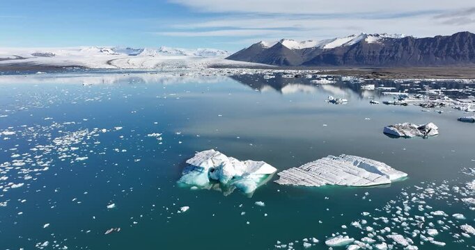 The stunning glacier in Iceland is captured beautifully in an aerial photograph on a clear and sunny day.