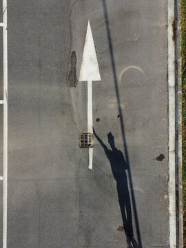 Aerial view of urban landscape with concrete roads and human shadows, Serravalle Scrivia, Italia.