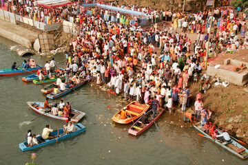 Aerial view of People thronging at Mula river side for immersion of idol of lord Ganesh, Pune, Maharashtra, India
