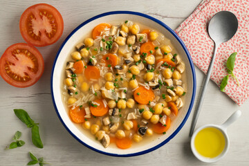 Chickpea and rice soup with mushrooms and vegetables. Top view table with  decorations.