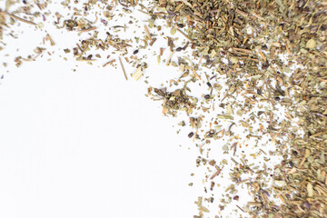Dry basil spice seasoning macro texture on white background.