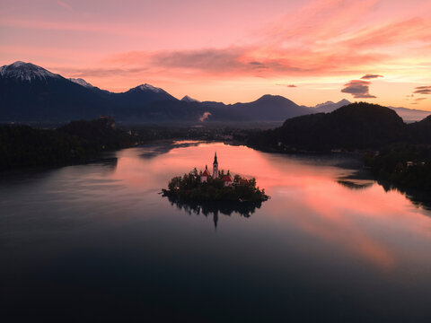 Aerial view of a serene sunrise over Lake Bled with a picturesque island and majestic church, Bled, Slovenia.