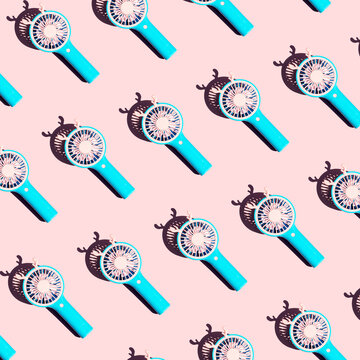 Pattern of blue hand fans on a pastel background