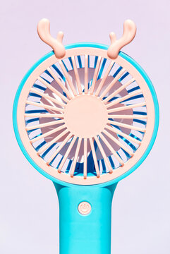 Colorful portable hand fan with whimsical antler design