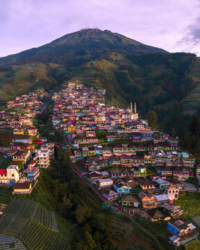 Aerial view of a majestic mountain village with colorful houses and a mosque at sunrise, Nepal Van Java, Indonesia.