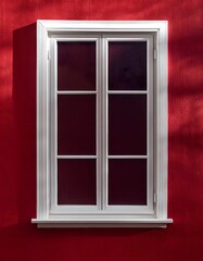 Fototapeta premium White window on a red wall