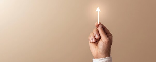 A hand holding a glowing arrow pointing upwards, symbolizing growth, progress, and direction on a neutral background.