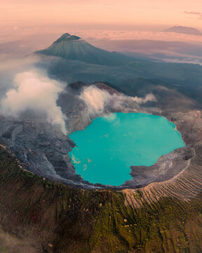 Aerial view of Kawah Ijen volcano with a beautiful lake and smoke at sunrise, Java, Indonesia.
