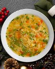 Vegetable soup with green beans and red pepper. Top view table with Christmas decoration.
