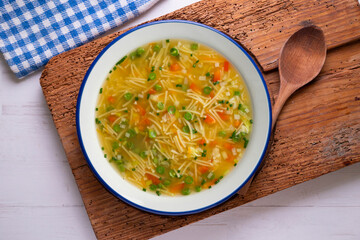 Vegetable soup with green beans and red pepper. Top view table with  decoration.