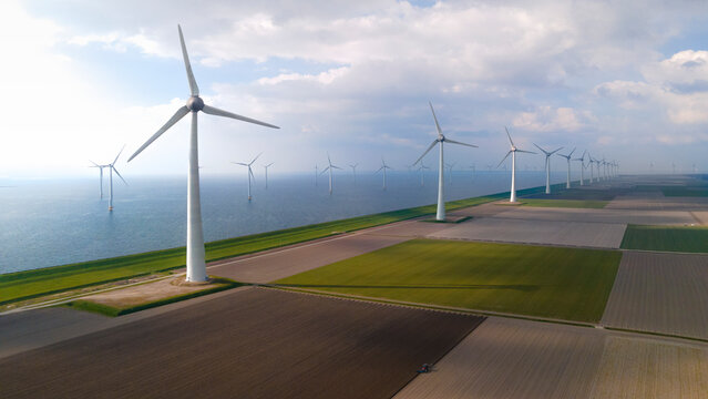 Aerial view of windfarm with windturbines and farmland near IJsselmeer, Dronten, Netherlands.