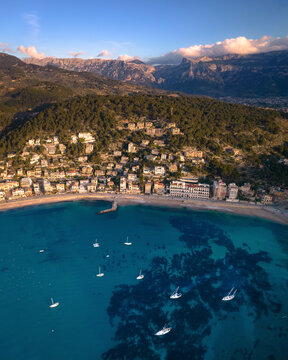 Aerial view of a picturesque sunset over the tranquil harbour filled with yachts, Soller, Mallorca, Spain.
