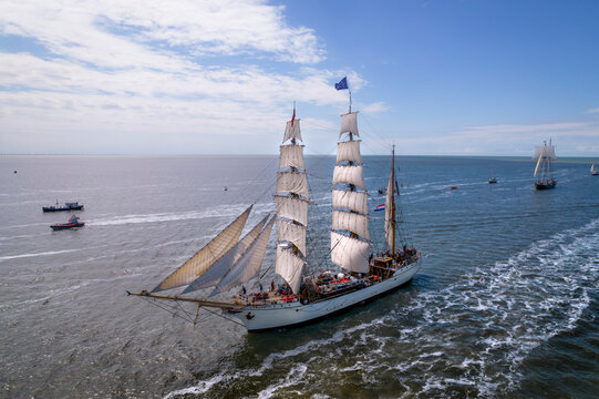 Harlingen, Netherlands - 14 July 2022: Aerial view of bark europa sailing on the open sea with blue sky and clouds, Harlingen, Netherlands. - Powered by Adobe