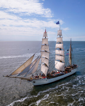 Harlingen, Netherlands - 14 July 2022: Aerial view of a tall ship sailing on calm sea under a blue sky, Harlingen, Netherlands.