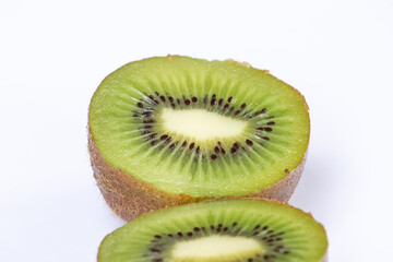 A natural and organic display of green kiwi slices, emphasizing their radial symmetry and fresh,...