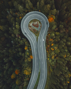 Aerial view of winding road with cars through beautiful autumn forest, Breitnau, Germany.
