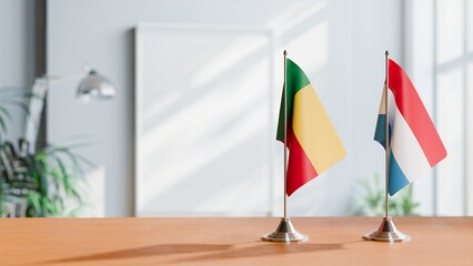 FLAGS OF BENIN AND LUXEMBOURG ON TABLE