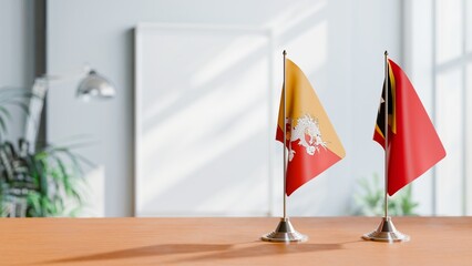 FLAGS OF BHUTAN AND EAST TIMOR ON TABLE