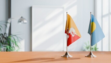 FLAGS OF BHUTAN AND PALAU ON TABLE