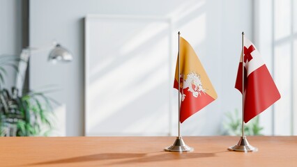 FLAGS OF BHUTAN AND TONGA ON TABLE