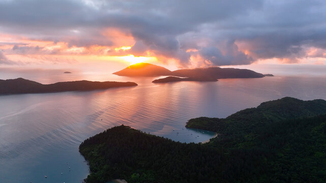 Aerial view of a beautiful sunset over a tranquil island and ocean with lush greenery, Angra dos Reis, Brazil.