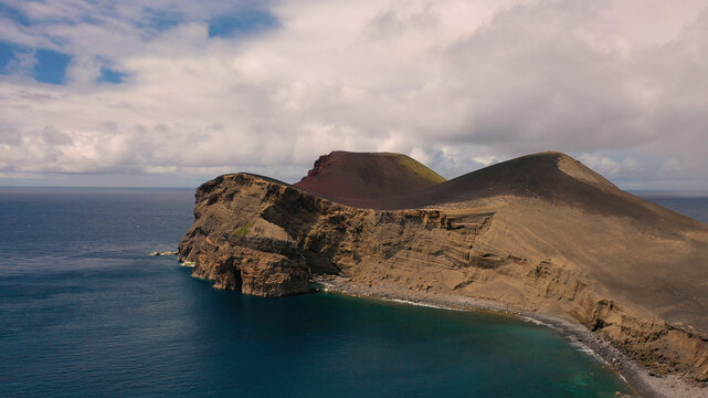 Aerial view of the breathtaking volcanic island with rugged cliffs and pristine ocean, Capelo, Azores, Portugal.