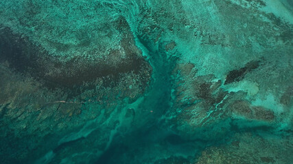 Aerial view of beautiful tropical island with vibrant coral reef and clear blue water, Samoa.