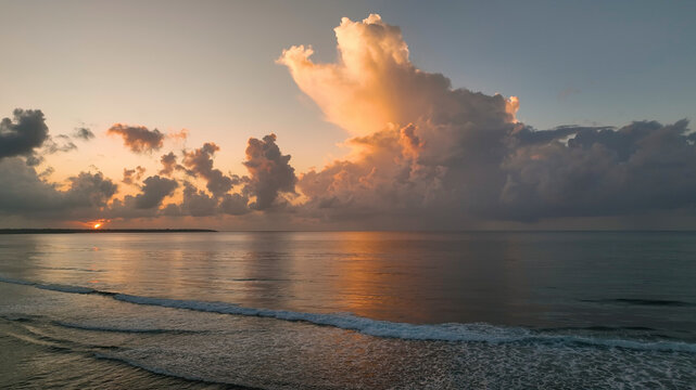 Aerial view of serene sunset over tropical ocean with dramatic clouds, Tuamasaga, Samoa.
