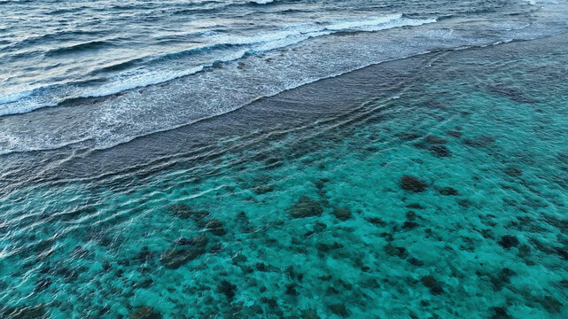 Aerial view of beautiful tropical reef and sandy beach with ocean waves, Bonaire, Caribbean Netherlands.
