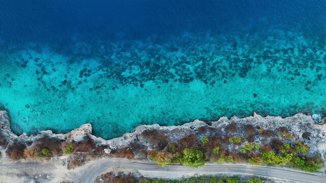 Aerial view of beautiful turquoise ocean and serene tropical reef with sandy beach, Bonaire, Caribbean Netherlands.