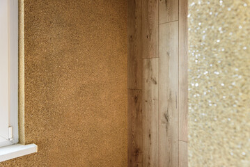 Applying decorative mosaic plaster on the wall.