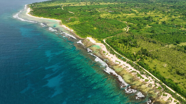 Aerial view of a beautiful tropical island with turquoise water, lush greenery, and crashing waves, Shefa, Vanuatu.