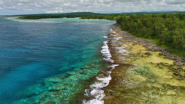 Aerial view of a beautiful tropical island with pristine reef and azure waves, Shefa, Vanuatu.