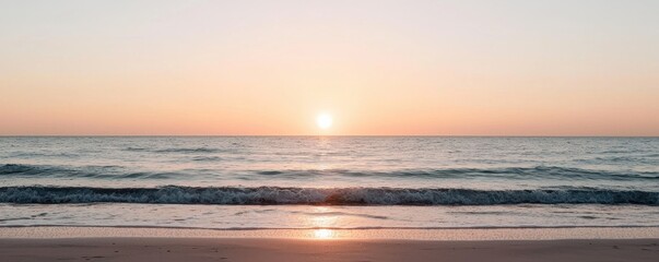 Obraz premium A breathtaking view of a sunset over a calm ocean, capturing serene hues of orange and pink reflecting on the water's surface.