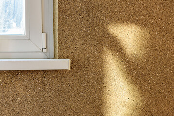 Applying decorative mosaic plaster on the wall.
