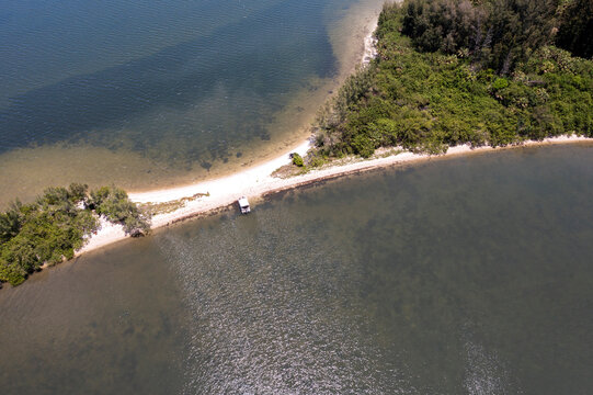 Aerial view of tranquil Roberts Island and the serene Indian River Lagoon with lush vegetation and sandy shoreline, Grant Valkaria, United States.