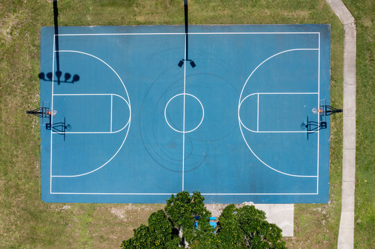 Aerial view of Knecht Park featuring a blue basketball court surrounded by trees and pathways, Palm Bay, United States.