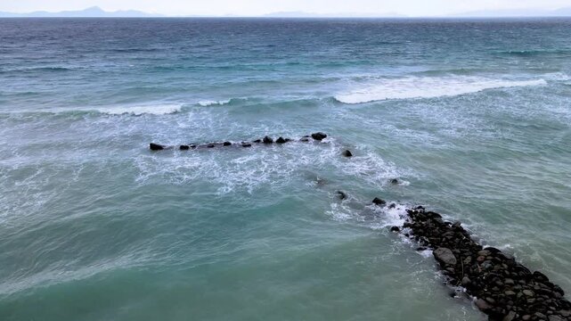 Group of Breakwater Rocks Standing Strong Against Sea Waves
