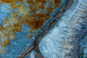 Aerial view of colorful and textured rock formations and terrain at Sunshine Mine, Fellsmere, Florida, United States.