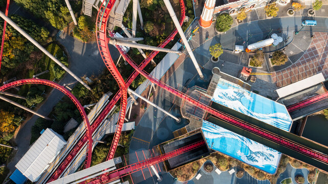Aerial view of colorful amusement park with dynamic roller coaster and thrill rides, Songjiang District, People's Republic of China.