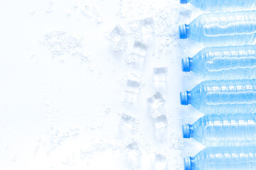 Pure frozen water in plastic bottles on white background top vie