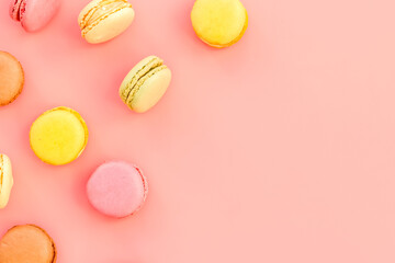 Macarons dessert pattern on pink background top view copy space