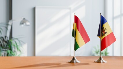 FLAGS OF BOLIVIA AND MOLDOVA ON TABLE